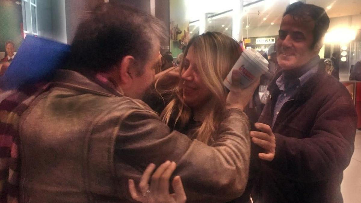 Iranian Fariba Tajrostami was embraced by her brothers Sunday at John F. Kennedy International Airport after arriving on her flight from Istanbul, Turkey. Tajrostami had tried to fly a week earlier but was turned away in Istanbul and sent back to Tehran, due to President Donald Trump's travel ban. When she heard a court had blocked the ban, she bought the first ticket she could to New York. She plans to join her husband, who moved from Iran last year and now has permanent residency, in Dallas.