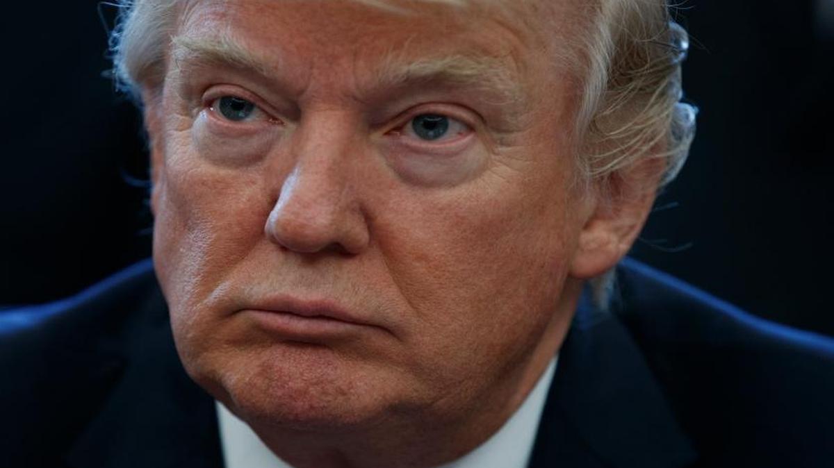 President Donald Trump pauses in the Oval Office of the White House in Washington Friday, March 24, 2017, during an announcement on the approval of a permit to build the Keystone XL pipeline, clearing the way for the $8 billion project.
