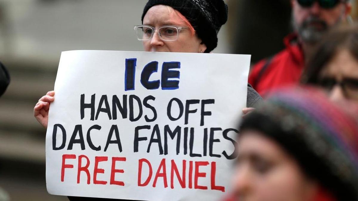 In this Feb. 17, 2017 photo, a protester holds a sign that reads "ICE Hands Off DACA Families Free Daniel," during a demonstration in front of the federal courthouse in Seattle. An immigration judge says a Mexican man who was arrested despite participating in a program designed to protect those brought to the U.S. illegally as children can be released from custody pending deportation proceedings.