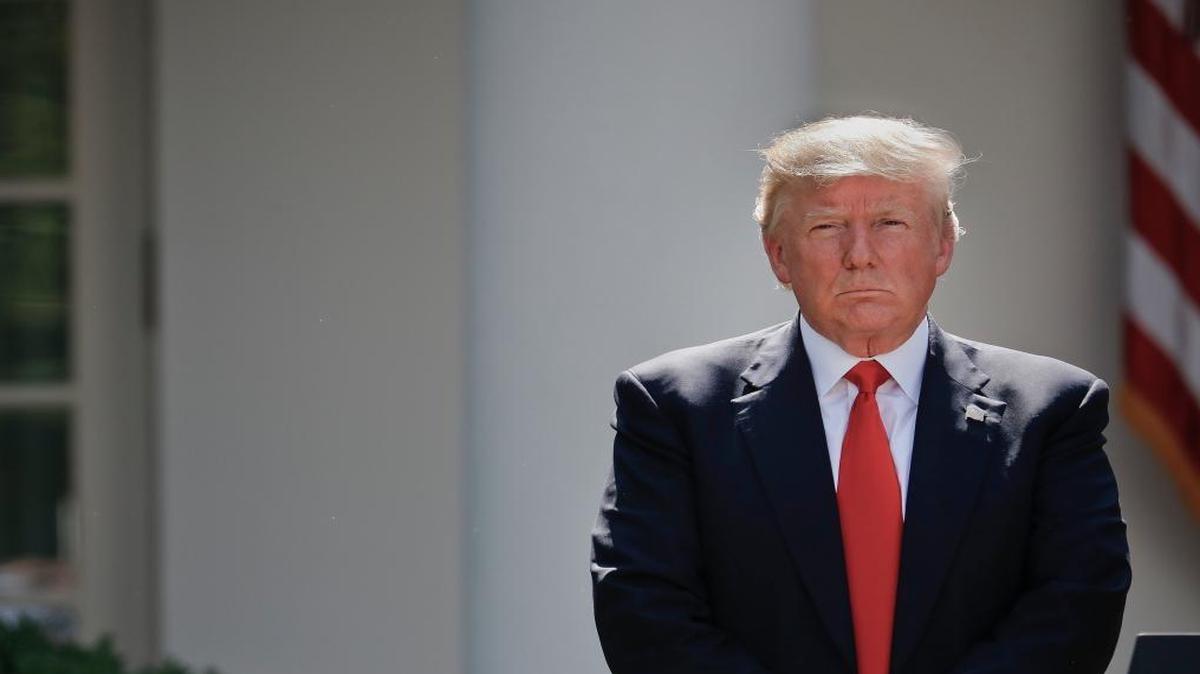 President Donald Trump stands next to the podium after speaking in the Rose Garden about the U.S. role in the Paris climate change accord,