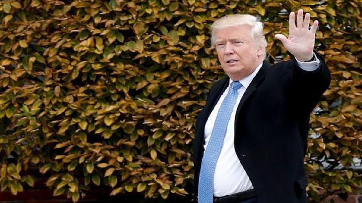President-elect Donald Trump waves as he arrives at the Trump National Golf Club Bedminster clubhouse, Sunday, Nov. 20, 2016, in Bedminster, N.J.
