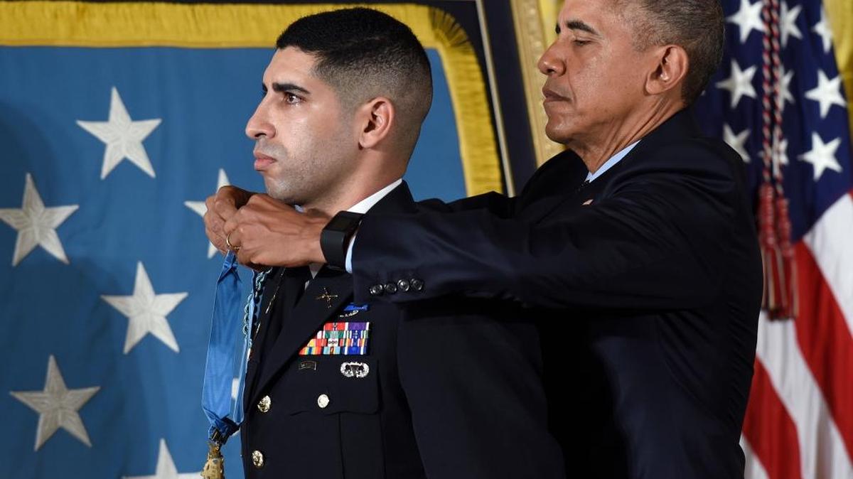 President Barack Obama bestows the Medal of Honor to retired U.S. Army Capt. Florent Groberg, for his actions during combat operations in Afghanistan, Thursday, Nov. 12, 2015, during a ceremony in the East Room of the White House in Washington.