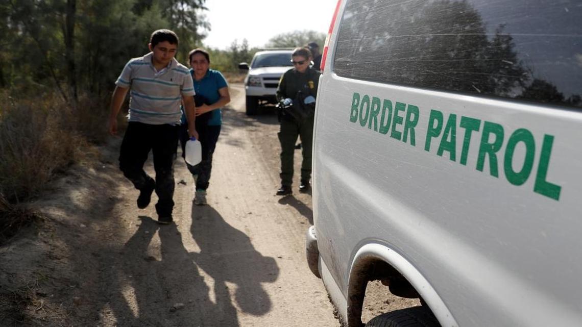 U.S. Customs and Border Patrol agents pick up immigrants suspected of crossing into the United States illegally along the Rio Grande near Granjeno, Texas on Aug. 11, 2017, photo.
