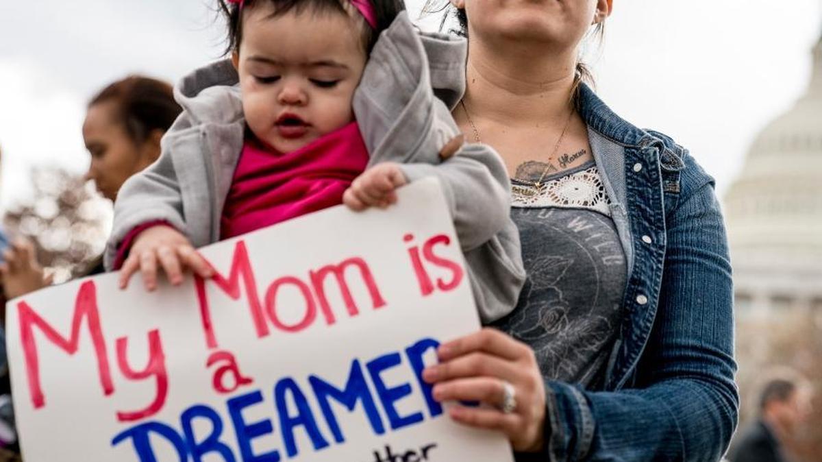 Yesenia Aguilar of Reading, Penn. holds her one year old daughter Denalli Urdaneta at an immigration rally on Capitol Hill in Washington, Tuesday, Jan. 23, 2018. Democrats and Republicans are re-launching the search for an immigration deal, fueled by fresh promises for a Senate vote, new concessions and good will after the agreement to reopen the federal government.