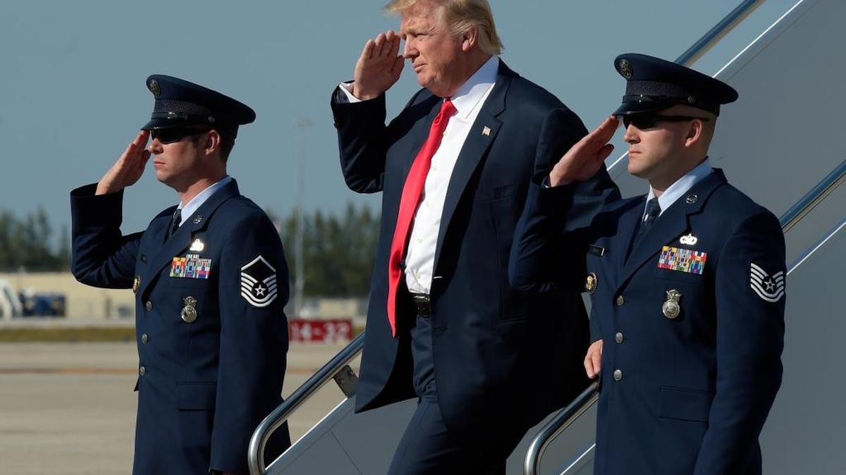 President Donald Trump salutes as he arrives a Palm Beach International Airport in West Palm Beach, Fla., Friday, Feb. 17, 2017. Trump is spending a third weekend in a row at his Mar-a-Lago estate.