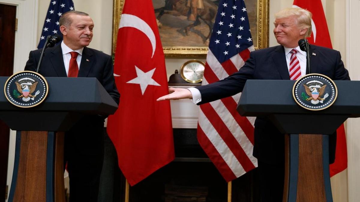 President Donald Trump reaches out to shake hands with Turkish President Recep Tayyip Erdogan in the Roosevelt Room of the White House, Tuesday, May 16, 2017, in Washington.