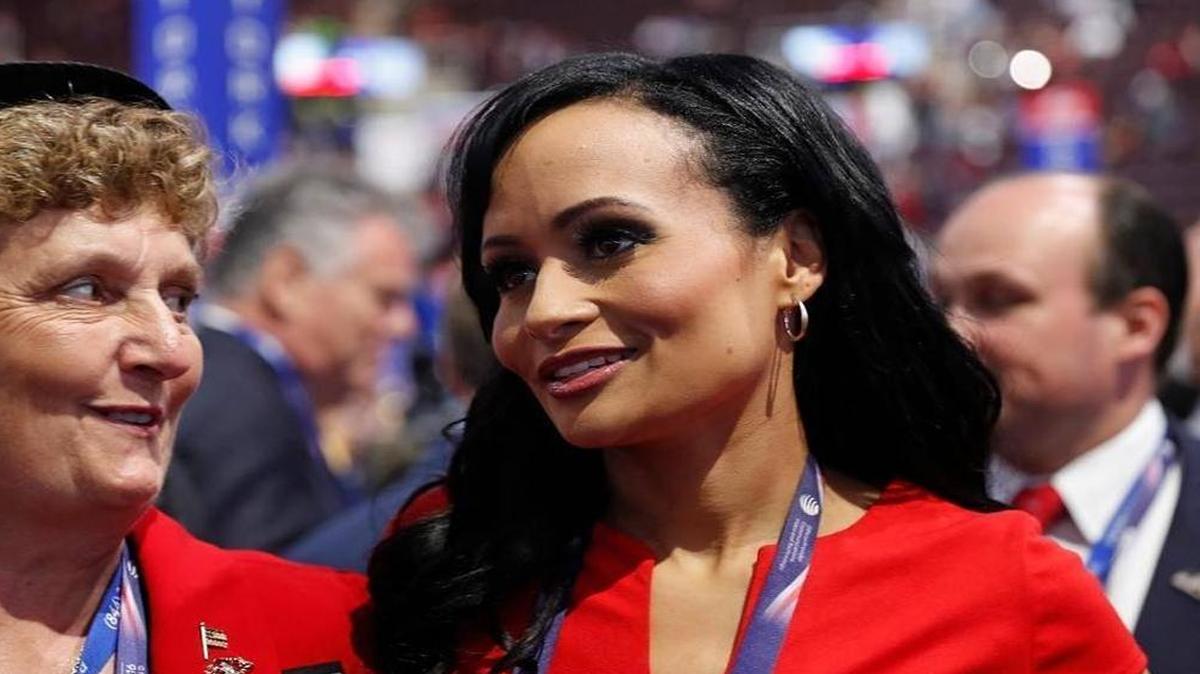 Katrina Pierson, right, talks with delegates on the convention floor during the final day of the Republican National Convention. Pierson was named to work on a pro-Trump non-profit on Monday.
