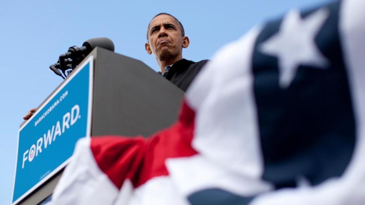 President Barack Obama pauses as he speaks during a campaign event at Bayliss Park, on Aug. 13, 2012, in Council Bluffs, Iowa, during a three day campaign bus tour through Iowa.