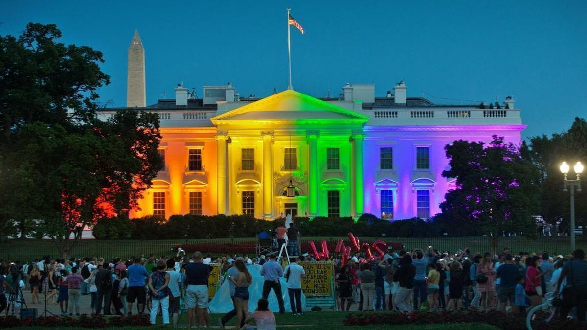 People gather in Washington's Lafayette Park to see the White House illuminated with rainbow colors to mark the U.S. Supreme Court's ruling that legalized same-sex marriage on June 26, 2015.