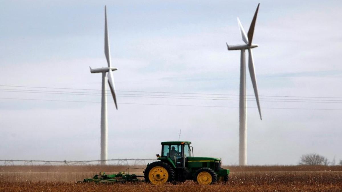 A farmer works in his fields near Roscoe, Texas. Roscoe is home to one of the largest wind farms in the world, and wind energy grew substantially during Gov. Rick Perry’s time in office.