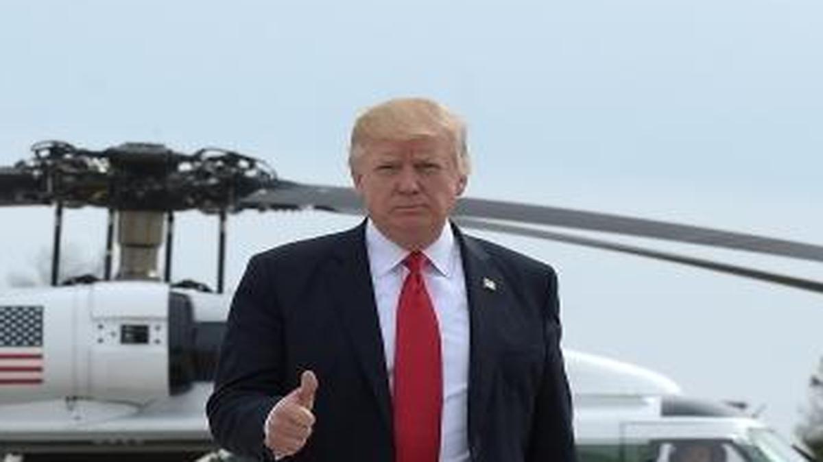 President Donald Trump gives a thumb-up as he walks from Marine One to Air Force One at General Mitchell International Airport in Milwaukee on Tuesday, April 18, 2017.