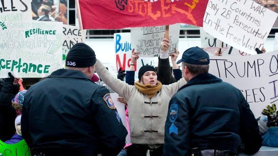 Police confronted protesters at the Gerald R. Ford International Airport in Grand Rapids, Mich., on Sunday, Feb. 5, 2017. Hundreds of people took part in protests of President Donald Trump's attempt to ban refugees and travelers from seven predominantly Muslim countries from entering the country.
