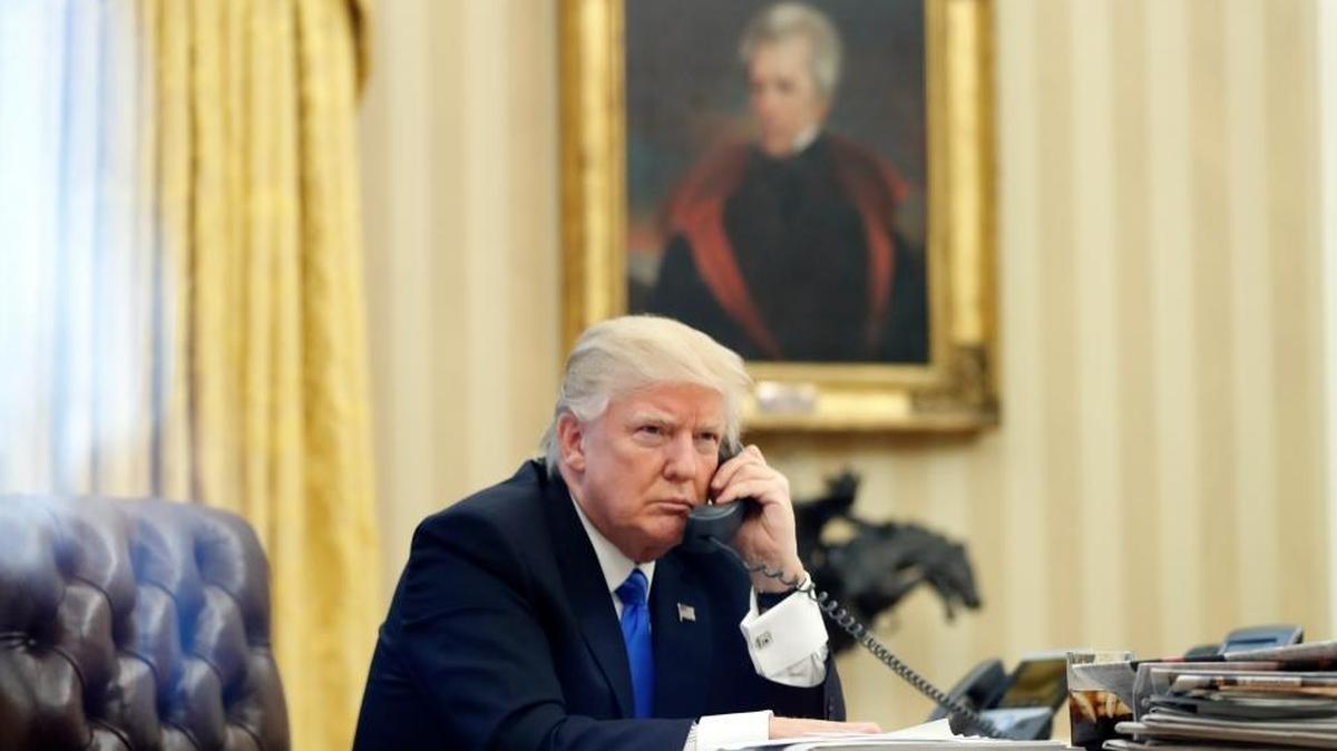 President Donald Trump speaks on the phone with Prime Minister of Australia Malcolm Turnbull in the Oval Office of the White House, Saturday, Jan. 28, 2017 in Washington.