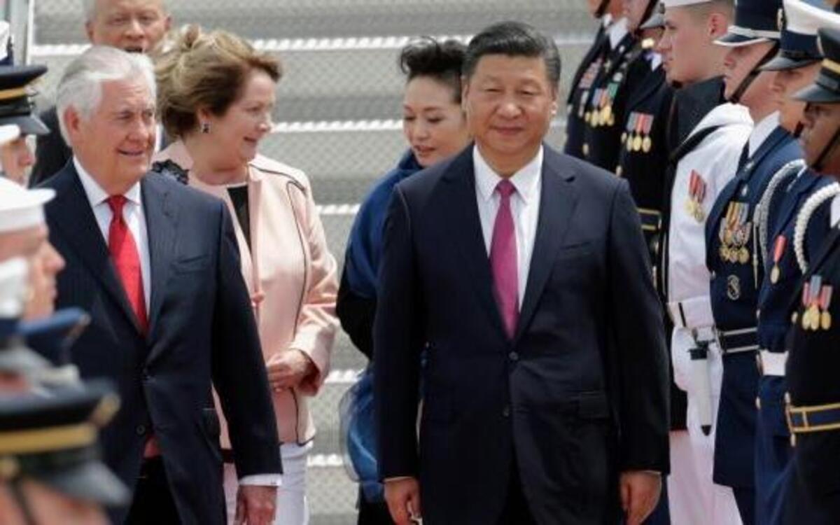 Secretary of State Rex Tillerson walks with Chinese President Xi Jinping at Palm Beach International Airport in West Palm Beach, Fla., Thursday, April 6, 2017. Xi was to meet with President Donald Trump later at Trump's Mar-a-Lago resort in Palm Beach.