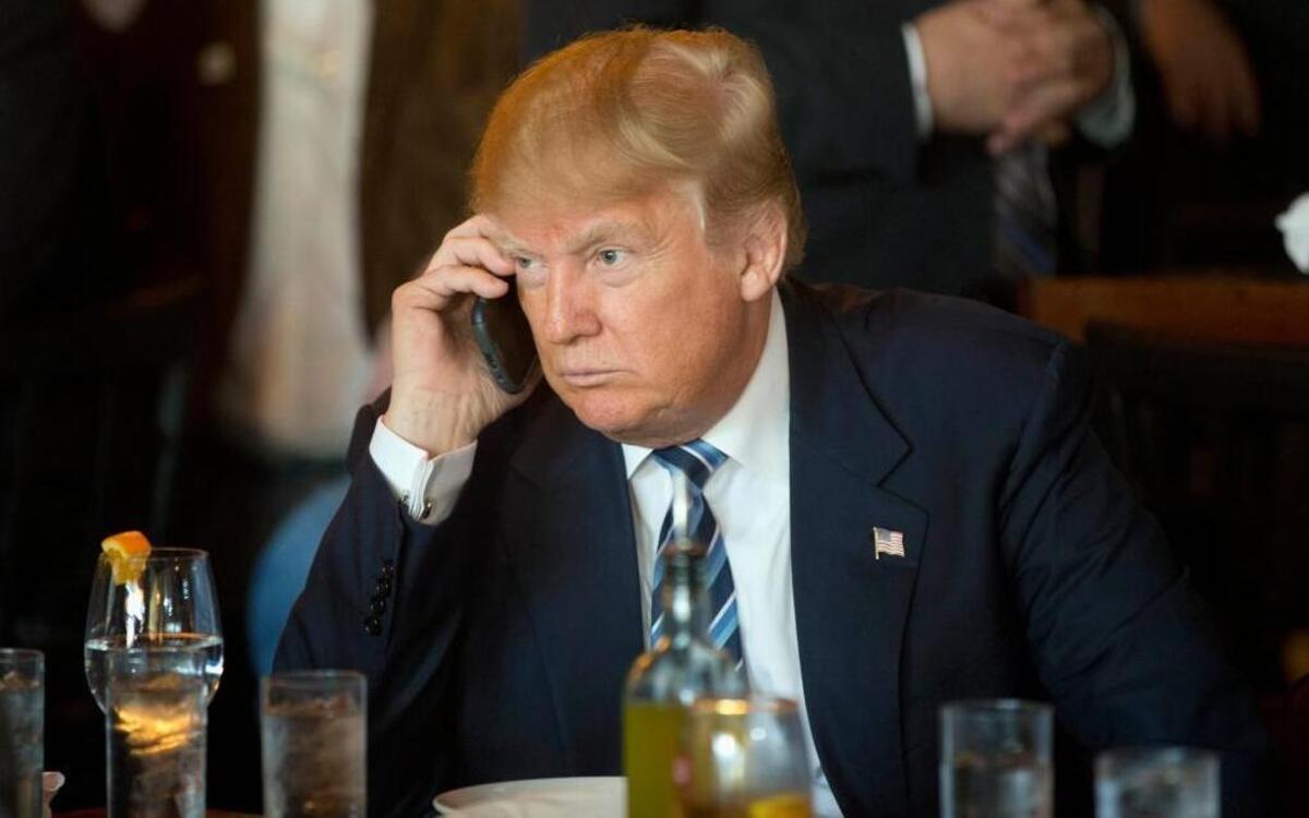 In this 2016 campaign file photo, President-elect Donald Trump, a frequent user of Twitter, listens to his cell phone. A new McClatchy-Marist poll found that a majority of voters said his use of Twitter was “reckless and distracting.”