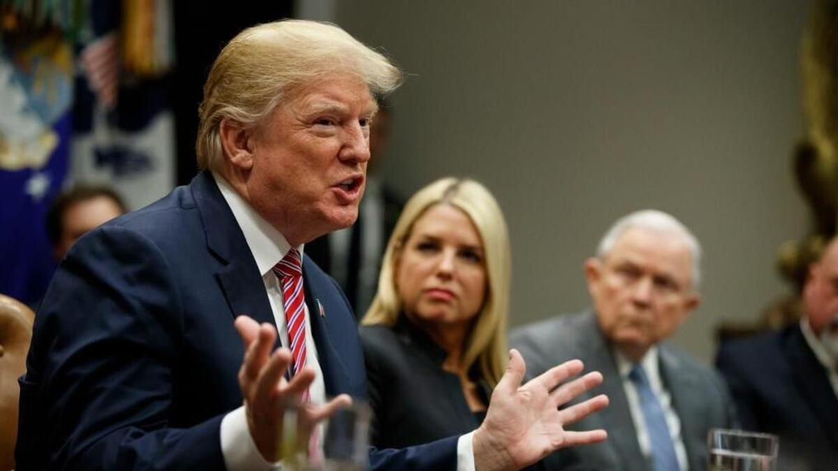 Florida Attorney General Pam Bondi, center, and Attorney General Jeff Sessions, right, look on as President Donald Trump speaks during a meeting with state and local officials to discuss school safety, in the Roosevelt Room of the White House, Thursday, Feb. 22, 2018, in Washington.