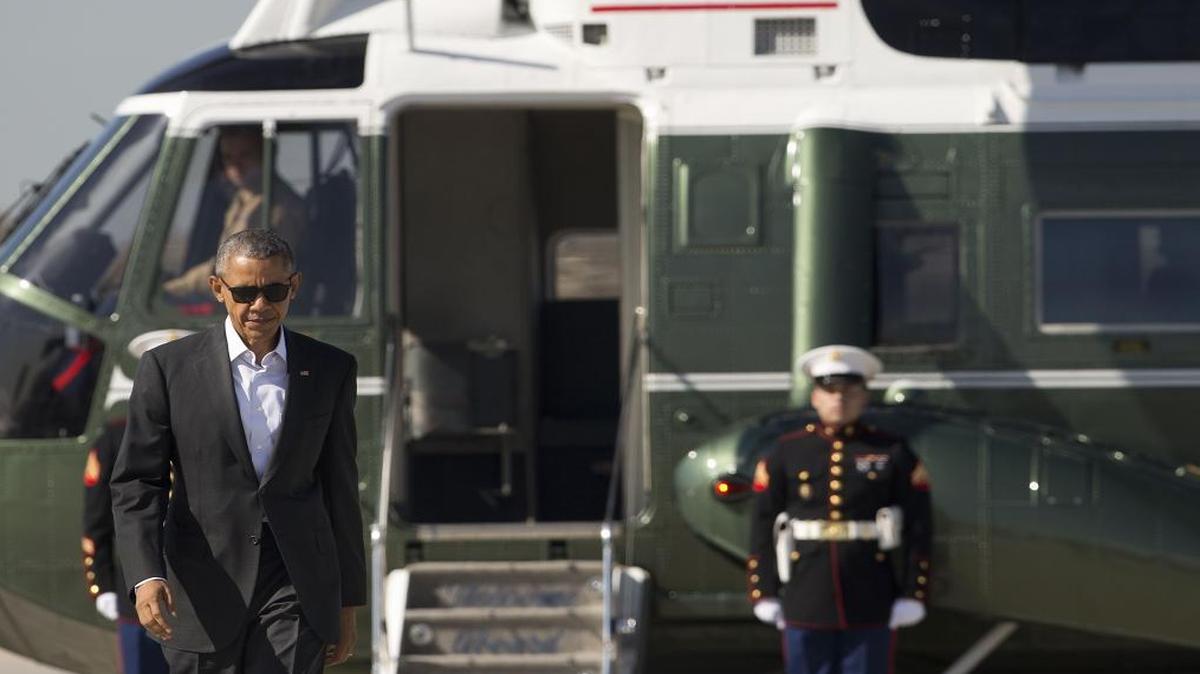 President Barack Obama walks across the tarmac from Marine One before boarding Air Force One at Los Angeles International Airport on Friday, Feb. 12, 2016, in Los Angeles.