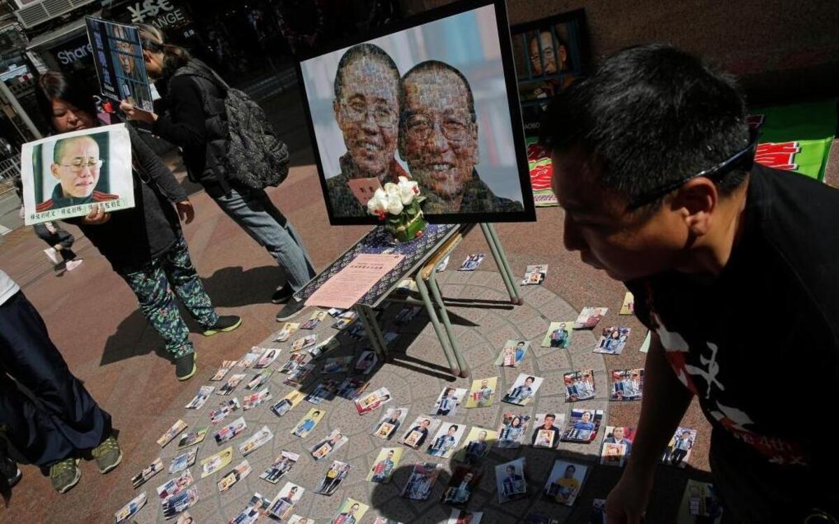 Protesters displayed a portrait of jailed Chinese Nobel Peace laureate Liu Xiaobo and his detained wife, Liu Xia, during a demonstration in Hong Kong on Saturday, April 1, 2017. Human rights activists and some in Congress want President Trump to press Chinese President Xi Jinping to release Liu Xiaobo and other political prisoners when the two leaders meet this week.