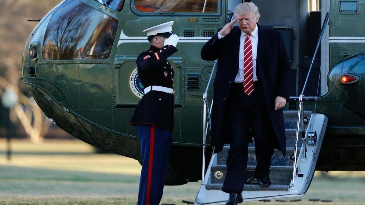 President Donald Trump salutes a Marines honor guard while he disembarks from Marine One, Monday, Feb. 6, 2017, as he returned to Washington from Florida.
