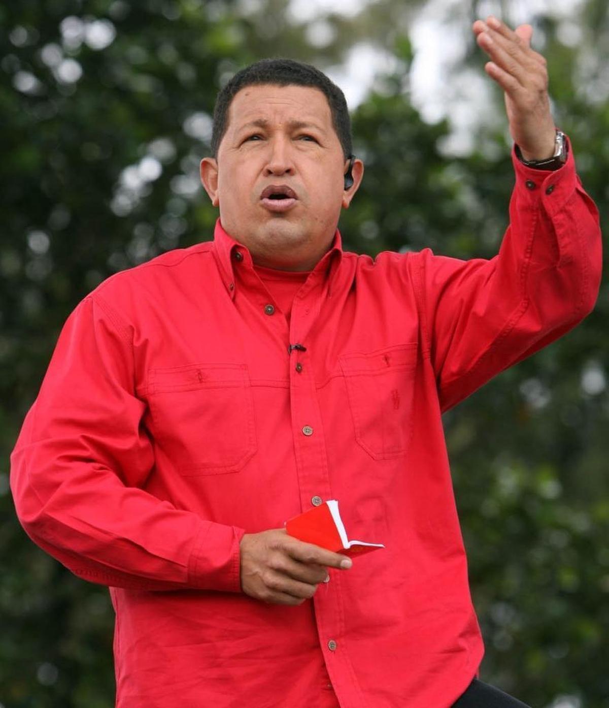 Venezuela's President Hugo Chavez speaks while holding a copy of the Venezuelan National Constitution during his weekly radio and television show known as "Hello President" in Caracas, Sunday, Oct. 7, 2007.