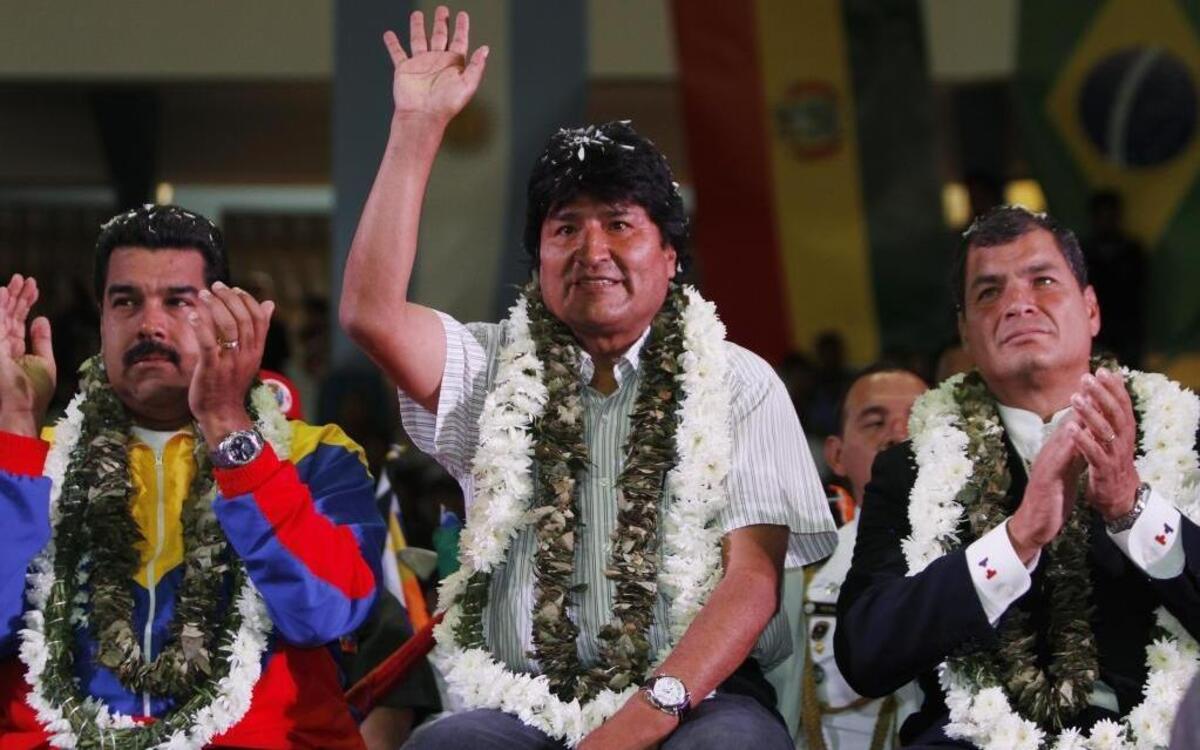 Venezuela's President Nicolas Maduro, left, Ecuador's President Rafael Correa, right, and Bolivia's President Evo Morales acknowledge supporters during a welcome ceremony for presidents attending an extraordinary meeting in Cochabamba, Bolivia, Thursday , July 4, 2013.