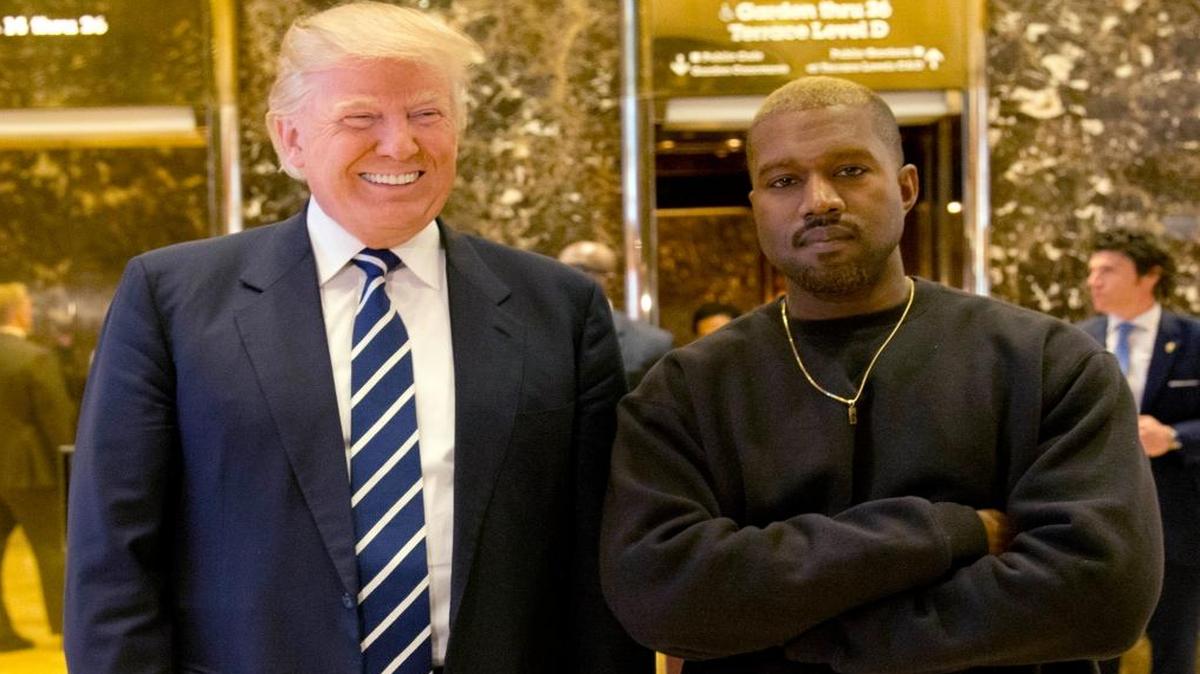 President-elect Donald Trump and Kanye West pose for a picture in the lobby of Trump Tower in New York Tuesday.