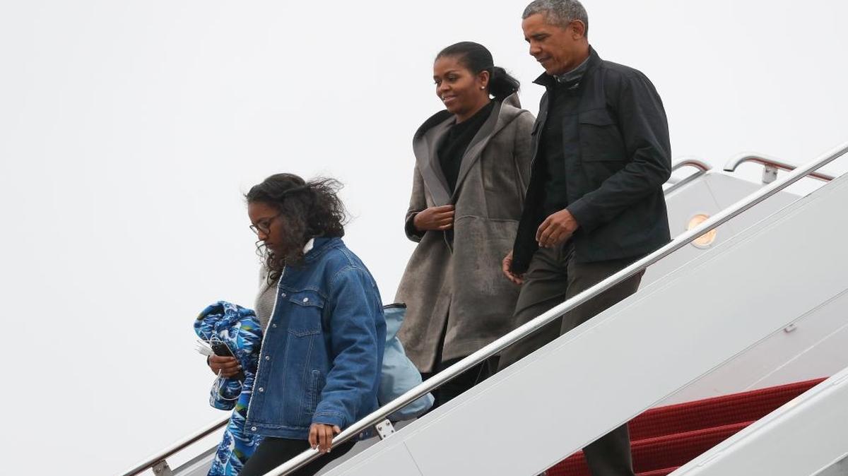 It probably was a lot warmer in Florida. President Barack Obama, first lady Michelle Obama and their daughter Sasha arrive on Air Force One, Monday, Jan. 2, 2017, in Andrews Air Force Base, Md., en route to Washington as they return from their annual vacation in Hawaii.