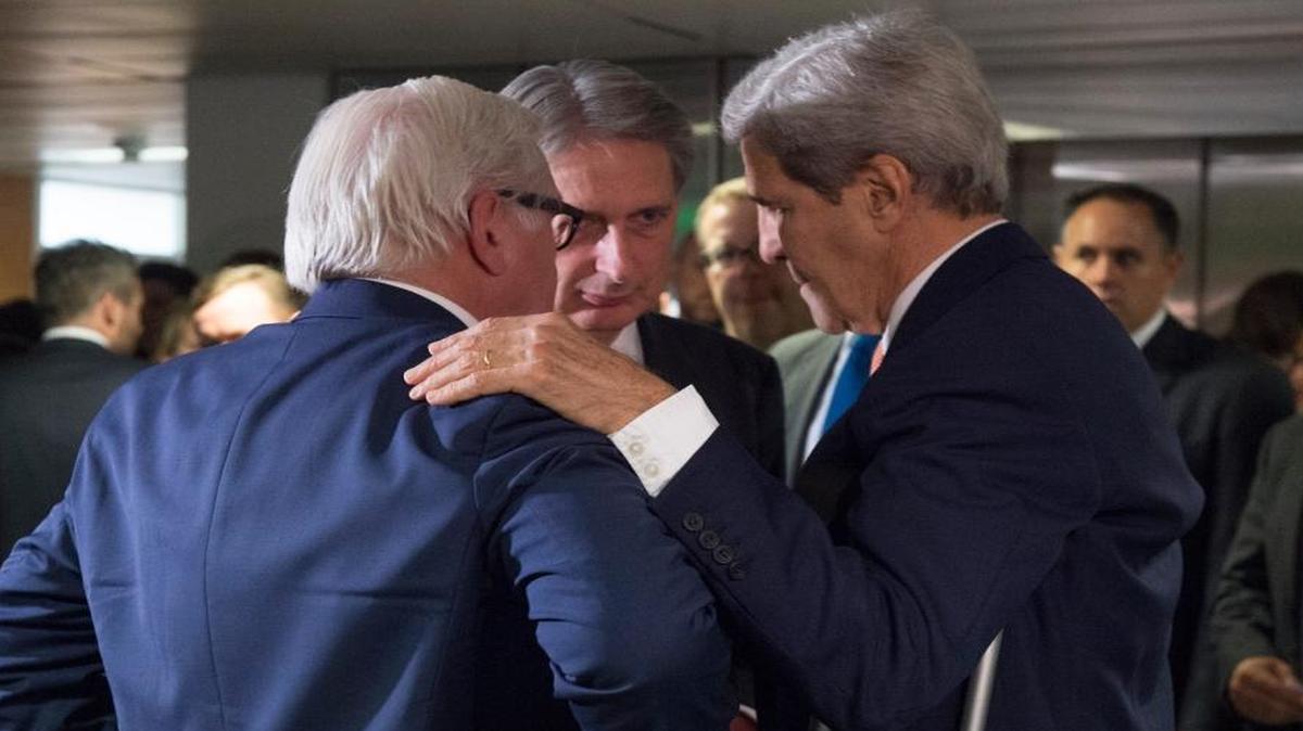 German Foreign Minister Frank-Walter Steinmeier, British Secretary of State for Foreign Affairs Philip Hammond and U.S. Secretary of State John Kerry talk prior to a plenary session at the United Nations building in Vienna, Austria, Tuesday, July 14, 2015. After 18 days of intense and often fractious negotiation, diplomats declared that world powers and Iran had struck a landmark deal to curb Iran's nuclear program in exchange for billions of dollars in relief from international sanctions, an agreement designed to avert the threat of a nuclear-armed Iran and another U.S. military intervention in the Muslim world.