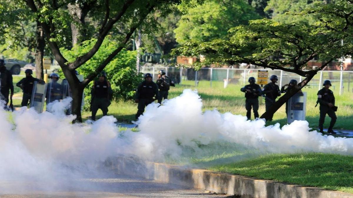 Venezuelan Bolivarian National Guard officers fire tear gas toward protesters in Valencia, Venezuela on Sunday Aug. 6, 2017. President Donald Trump raised the prospect of “military action” in Venezuela Friday, further heightening tensions in the oil-rich country.