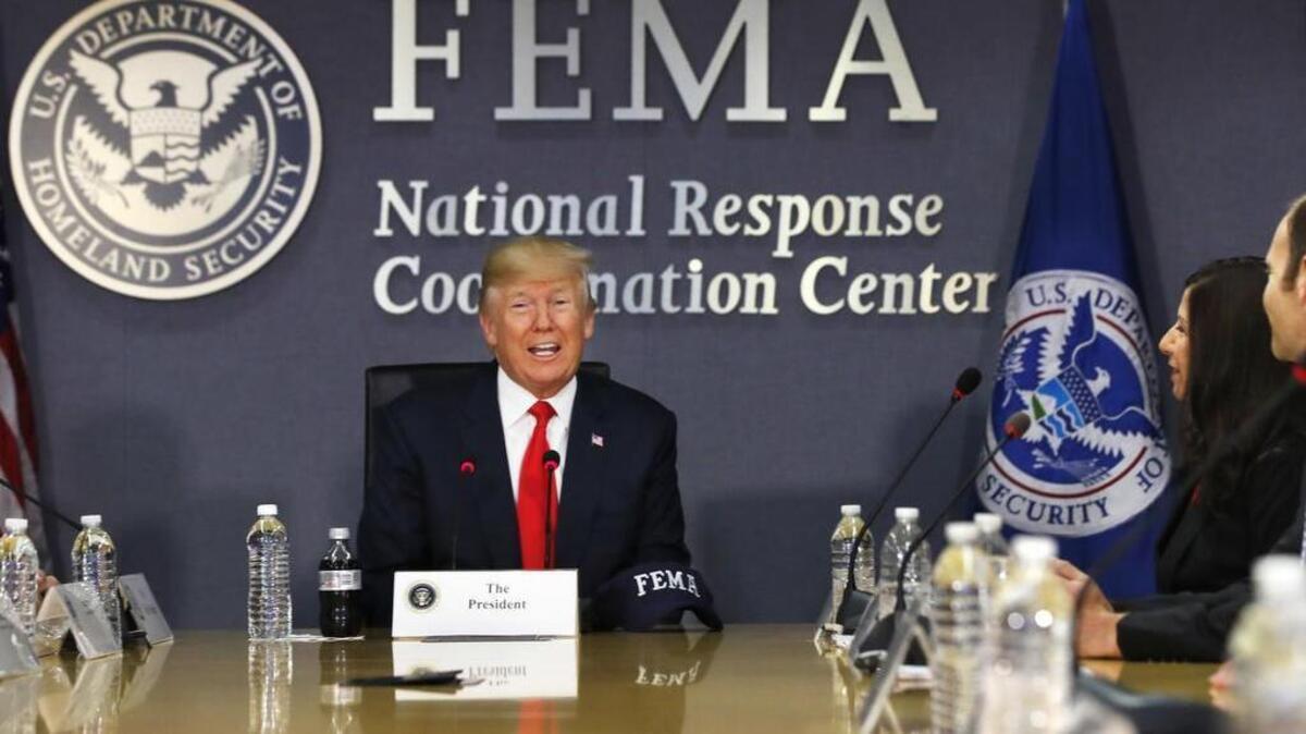 President Donald Trump meets with emergency officials to discuss the hurricane season, Friday, Aug. 4, 2017, at Federal Emergency Management Agency (FEMA) headquarters in Washington. At right is Acting Homeland Security Secretary Elaine Duke.