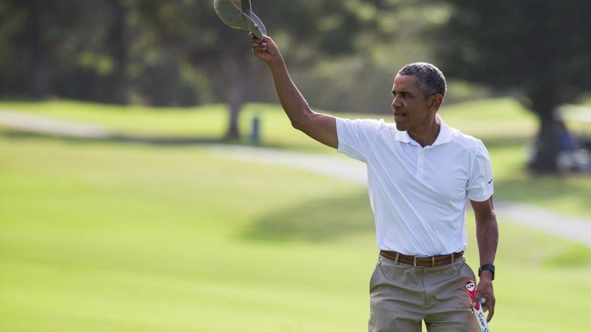 President Barack Obama tips his hat to the crowd after finishing a round of golf at Mid-Pacific Country Club during his family vacation, on Monday, Dec. 28, 2015, in Kailua, Hawaii.