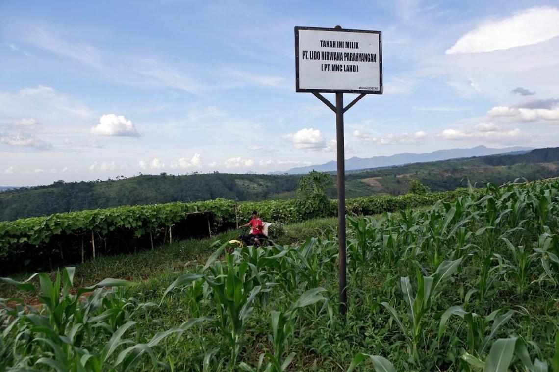 A sign that says the land is owned by MNC Land is erected on a farming field near Gunung Gede Pangrango National Park in Bogor, West java, Indonesia. A sprawling "Trump Community" will rise next to Gunung Gede Pangrango National Park.