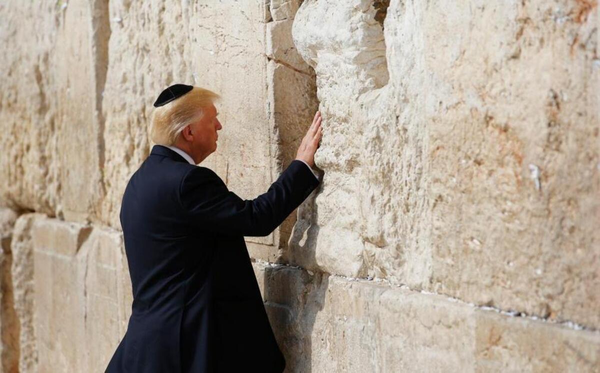 President Donald Trump touches the Western Wall, Judaism’s holiest prayer site, in Jerusalem’s Old City on May 22, 2017. Wednesday, Trump signed a waiver that delays moving the U.S. Embassy to Jerusalem from Tel Aviv.