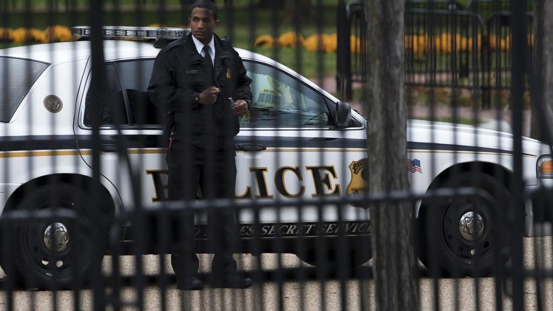 A Secret Service police officer stands at his post outside the White House fence in Washington, Thursday, Oct. 23, 2014.