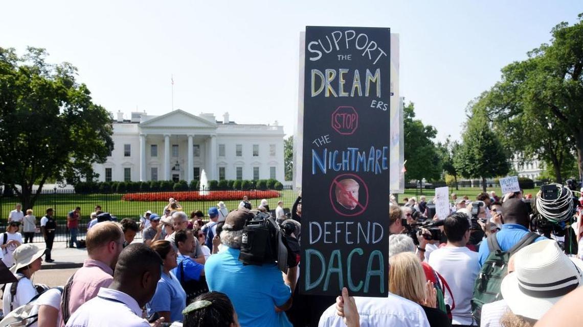 Protesters hold up signs during a rally supporting Deferred Action for Childhood Arrivals, or DACA, outside the White House. Thousands are expected to gather for rallies on Tuesday, when President Trump is slated to announce the future of the program.