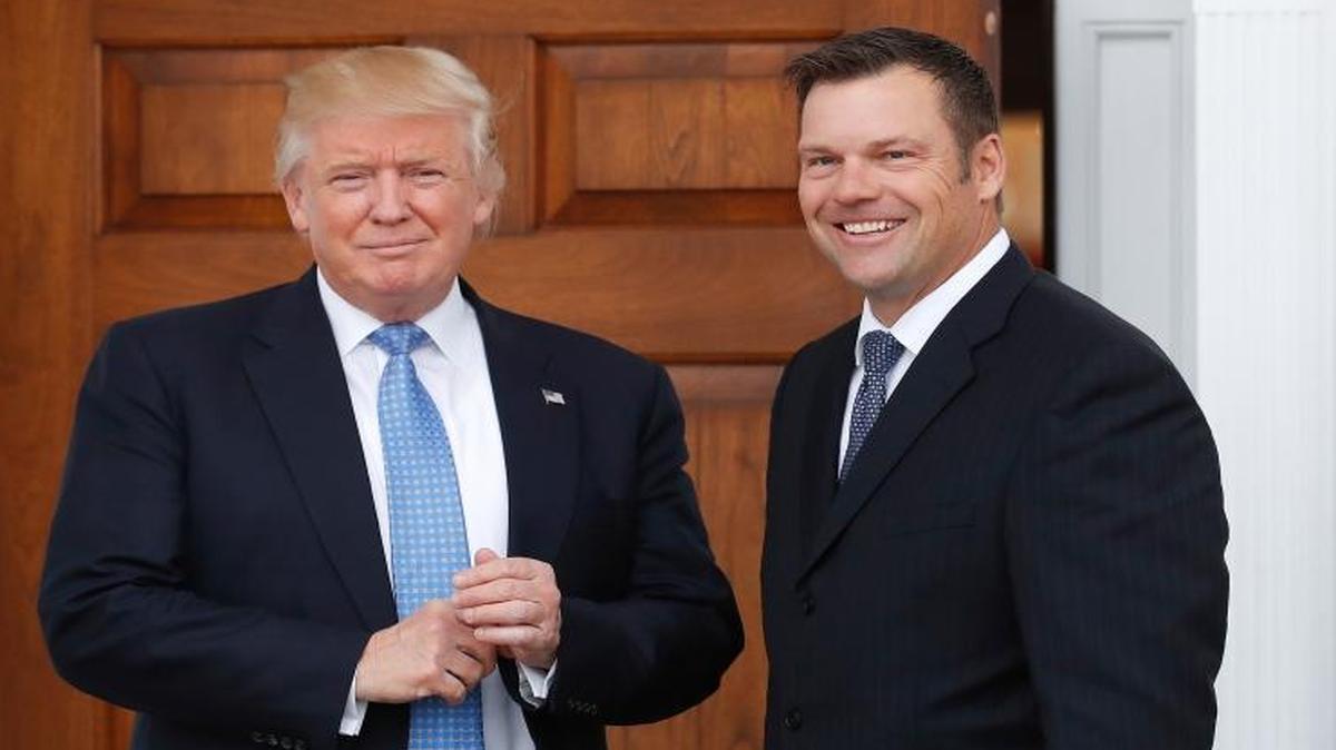 President-elect Donald Trump pauses for photographs as he greets Kansas Secretary of State Kris Kobach at the Trump National Golf Club Bedminster clubhouse, in Bedminster, N.J., on Nov. 20, 2016.