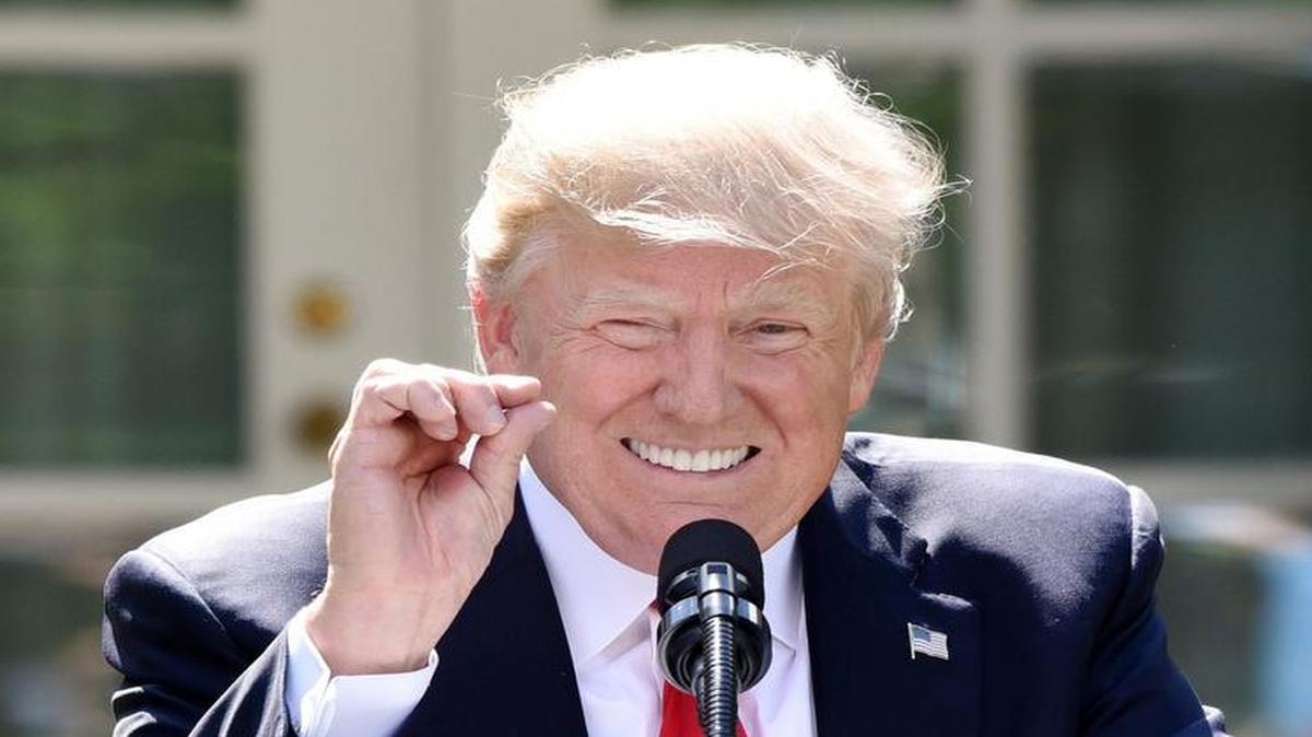 President Donald Trump gestures to indicate his belief that the Paris climate change accord would do very little to ease global warming.