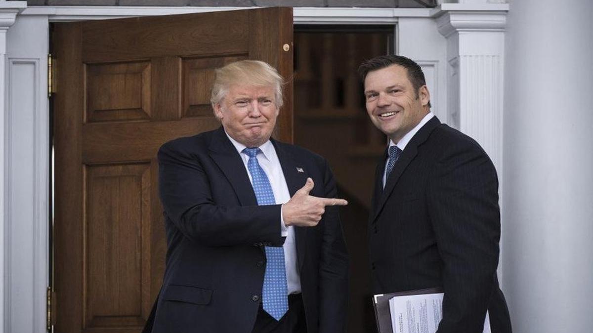 Then-President-elect Donald Trump greets Kansas Secretary of State Kris Kobach at the clubhouse at Trump National Golf Club Bedminster in Bedminster Township, N.J.
