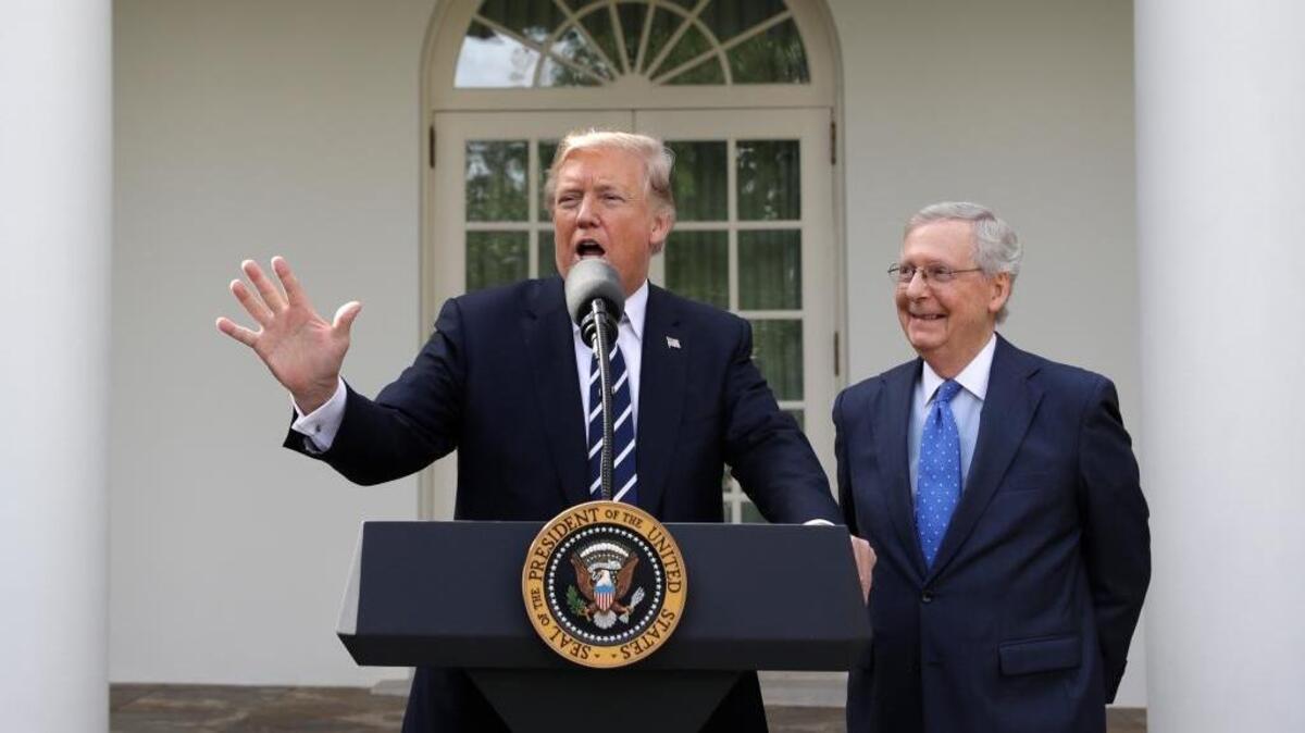 President Donald Trump answers questions with Senate Majority Leader Mitch McConnell, R-Ky., in the Rose Garden after their meeting at the White House, Monday, Oct. 16, 2017, in Washington.