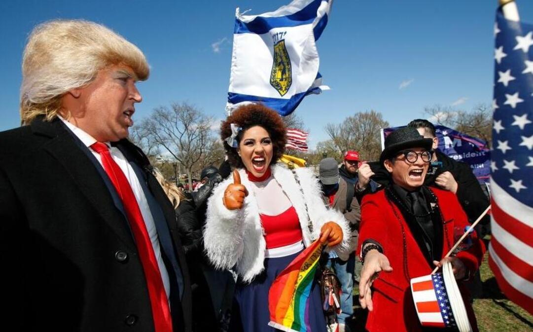 Supporters of President Donald Trump, from left, comedian Dustin Gold, singer Joy Villa and fashion designer Andre Soriano, cheer during a rally organized by the North Carolina-based group Gays for Trump, at the National Mall near the Washington Monument in Washington, March 4, 2017. The speakers at the rally talked about immigration, gay rights and several other issues and later marched from the National Mall to the White House.