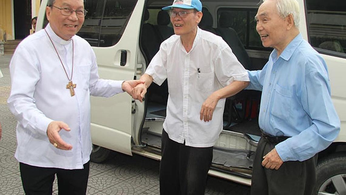 In this Friday May 20, 2016 photo released by the Catholic Archdiocese of Hue, Catholic priest Nguyen Van Ly, center, is welcomed back by Archbishop Tadeo, left, and a senior colleague to his parish in Hue, Ha Nam province, Vietnam. Vietnam granted early release from prison to Ly who is one of its most prominent dissidents, a move widely seen as a goodwill gesture before U.S. President Barack Obama arrives on an official visit late Sunday night. Ly has been serving an eight-year prison term since March 2007 after being convicted of spreading propaganda against the state.