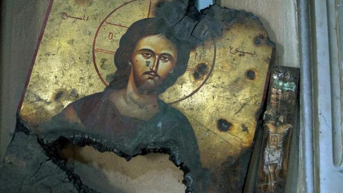 A half-burned image of Christ is placed next to a wall at a Greek Orthodox church in Maaloula, Syria, Thursday, March 3, 2016. Maaloula, an ancient Christian town 40 miles northeast of Damascus, changed hands several times in the war. Its historic churches pillaged by jihadis and buildings riddled with shrapnel reflect fierce fighting that devastated the town two years ago.