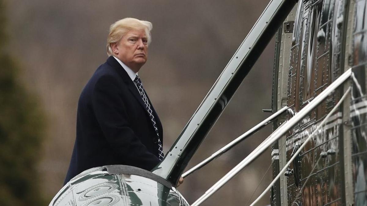 President Donald Trump boards Marine One as he leaves Walter Reed National Military Medical Center in Bethesda, Md., Friday, Jan. 12, 2018.