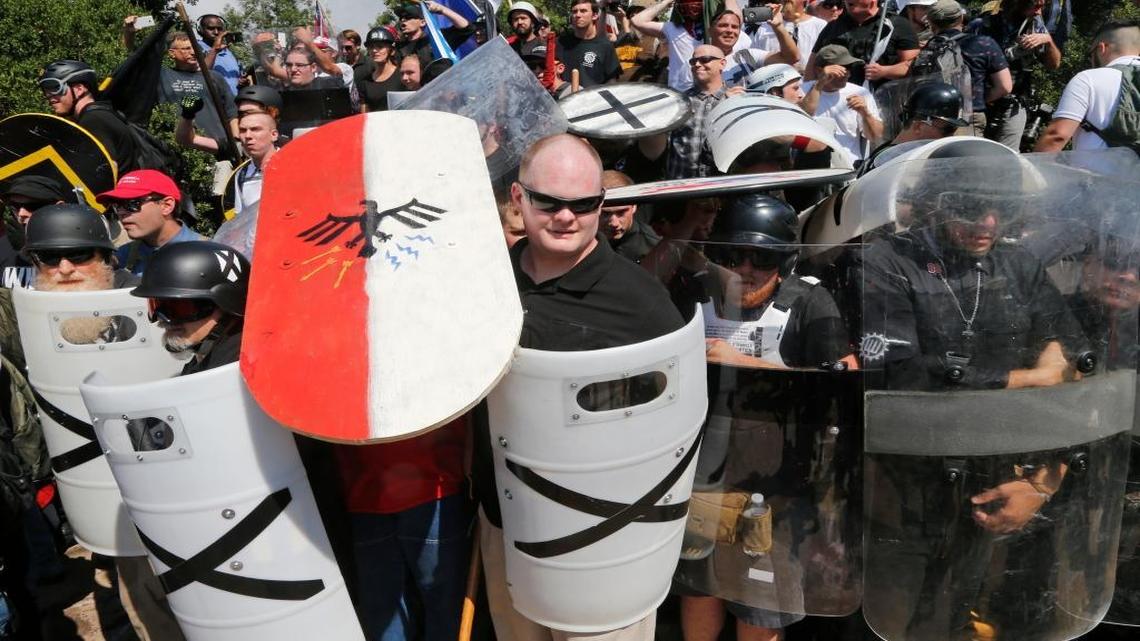White nationalist demonstrators use shields as they guard the entrance to Lee Park in Charlottesville, Va., Saturday, Aug. 12, 2017.