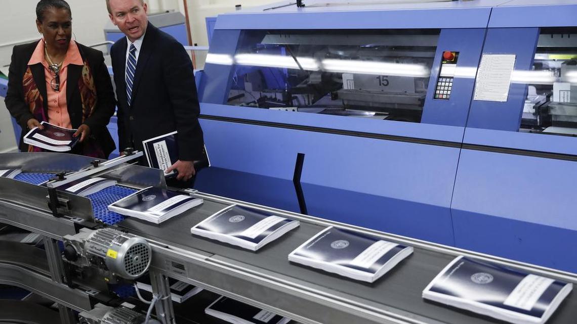 White House budget director Mick Mulvaney, right, joined by GPO Director Davita Vance-Cooks, inspects the production run of President Donald Trump's fiscal 2018 federal budget, Friday, May 19, 2017, at the U.S. Government Publishing Office's (GPO) plant in Washington.