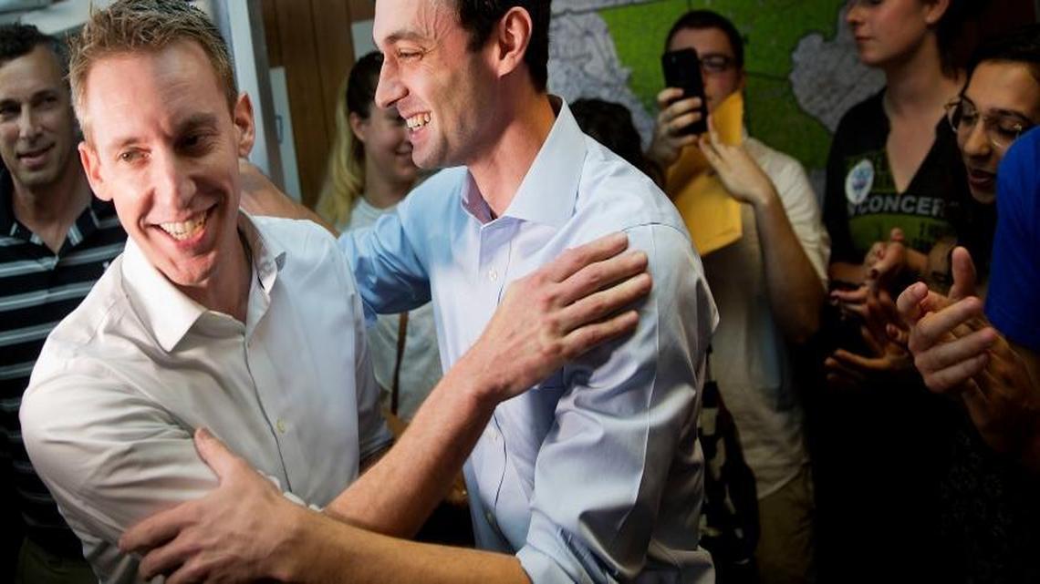 Jason Kander, left, former Missouri Secretary of State, campaigns for Jon Ossoff, Democratic candidate for Georgia's 6th congressional district, right, during a stop at Ossoff's campaign office in Chamblee, Ga., Monday, June 19, 2017.