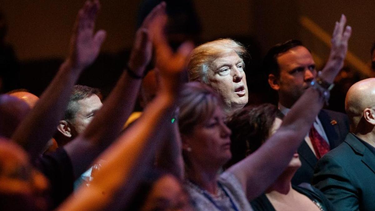 FILE- In this Oct. 30, 2016, file photo, Republican presidential candidate Donald Trump stands during a service at the International Church of Las Vegas in Las Vegas. Evangelical leaders are hoping that conservative support for Trump will translate into backing for other GOP candidates this fall.
