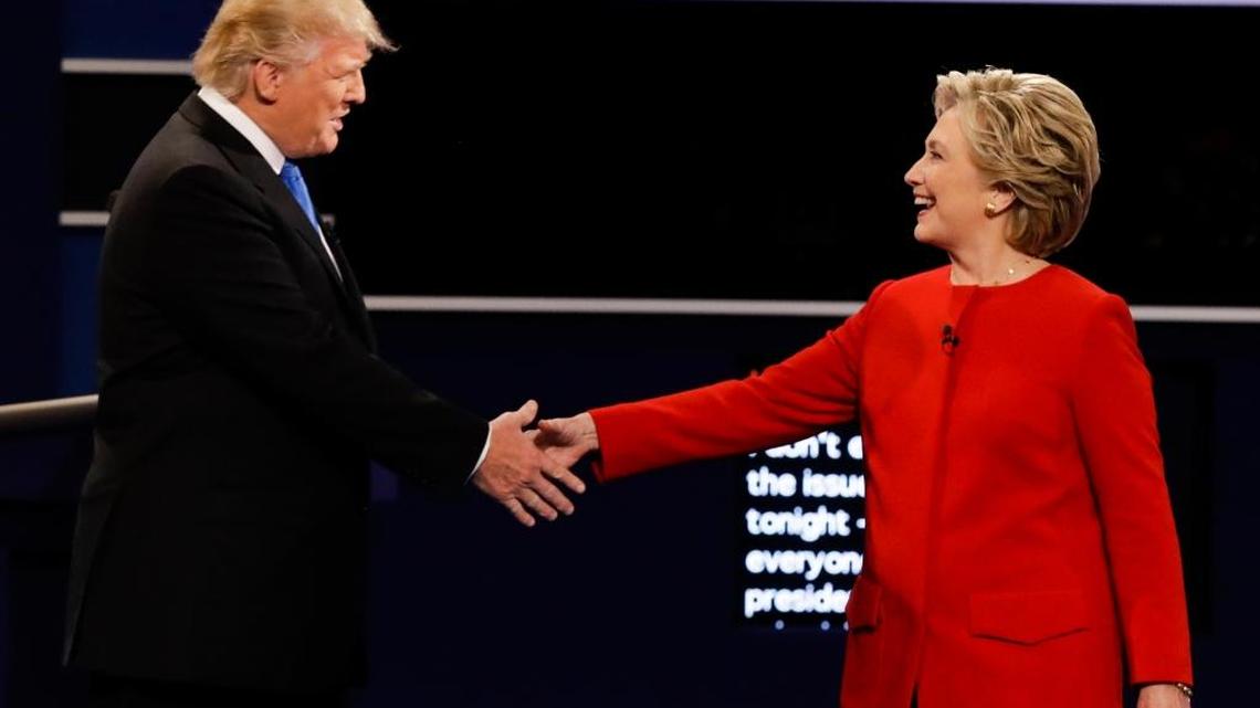 Republican presidential nominee Donald Trump and Democratic presidential nominee Hillary Clinton shake hands during the presidential debate at Hofstra University in Hempstead, N.Y. on Monday.