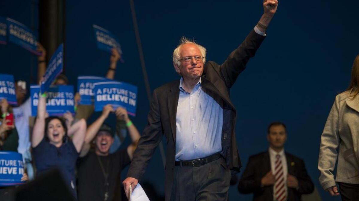 Democratic presidential candidate Bernie Sanders enters the stage during a rally at Bonney Field on Monday.