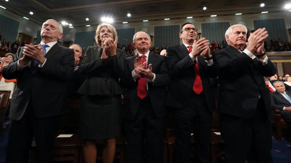 Defense Secretary Jim Mattis, Education Secretary Betsy DeVos, Attorney General Jeff Sessions, Treasury Secretary Steve Mnuchin and Secretary of State Rex Tillerson applaud as President Donald Trump speaks on Capitol Hill in Washington, Tuesday.